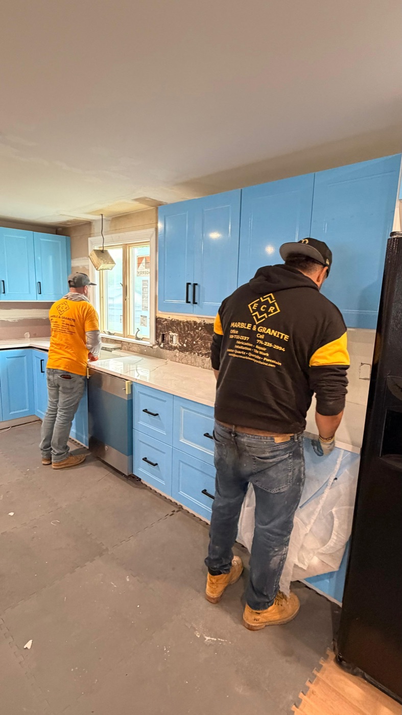 ECR Marble and Granite crew installing white quartz countertops in a Massachusetts kitchen